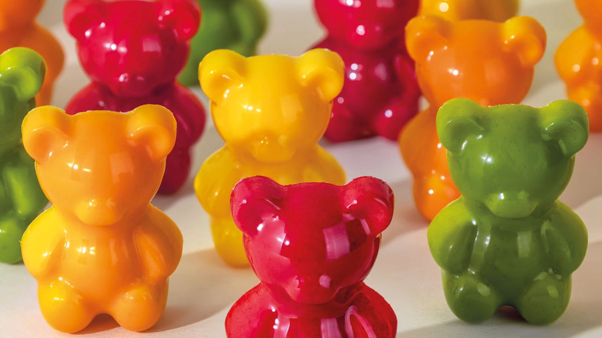 Glossy red, orange, yellow and green bear-shaped chocolates